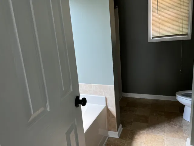 a kitchen with granite countertop stainless steel appliances a sink stove and refrigerator