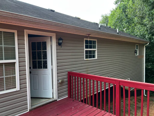 a view of deck with two chairs and wooden fence