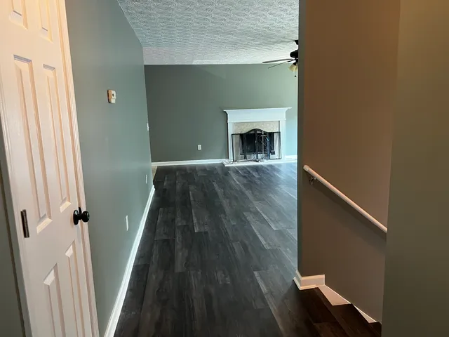 a view of a livingroom with wooden floor and fireplace