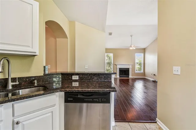 a bathroom with a granite countertop sink a large mirror and a shower