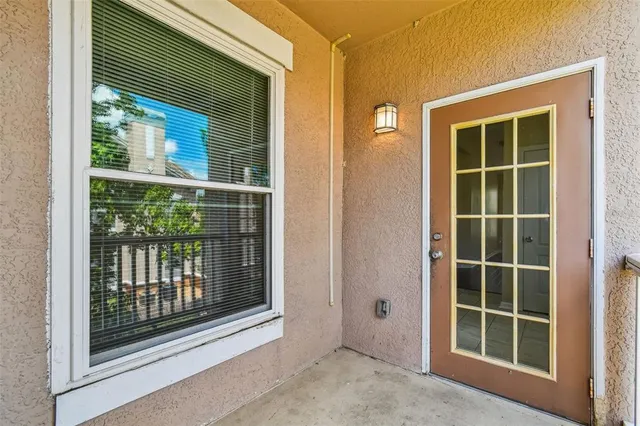 an empty room with a ceiling fan and a window