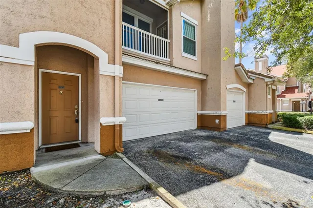 a roof deck with a table and chairs next to a yard