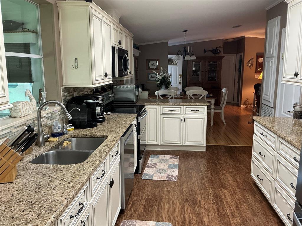 236 Allies Pass, Unit 363 Frostproof, FL 33843 - Photo 17 of 51 a kitchen with a sink stove and refrigerator