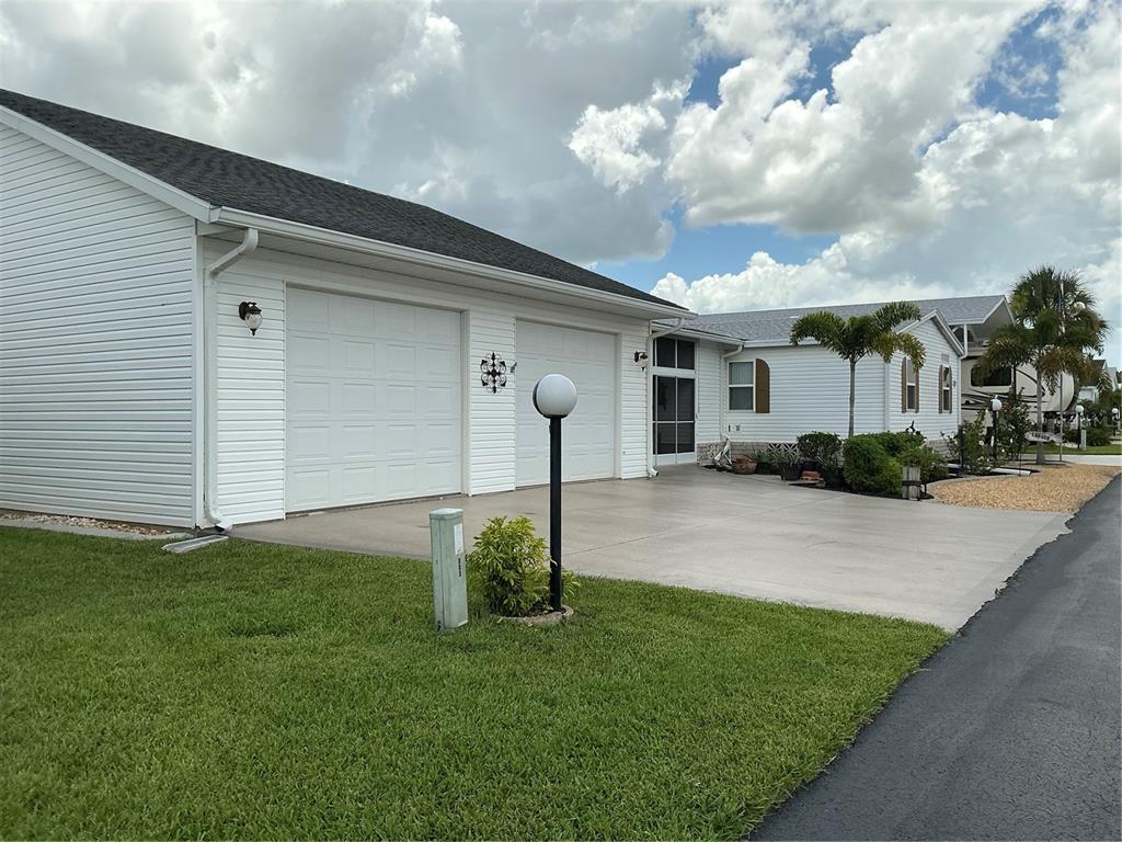 236 Allies Pass, Unit 363 Frostproof, FL 33843 - Photo 2 of 51 a front view of a house with garden