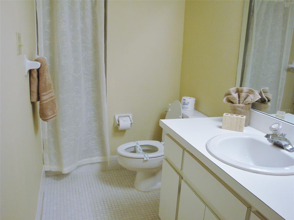 244 Cypress Lane, Unit 244 Oldsmar, FL 34677 - Photo 11 of 16 a white toilet sitting next to a bathroom sink
