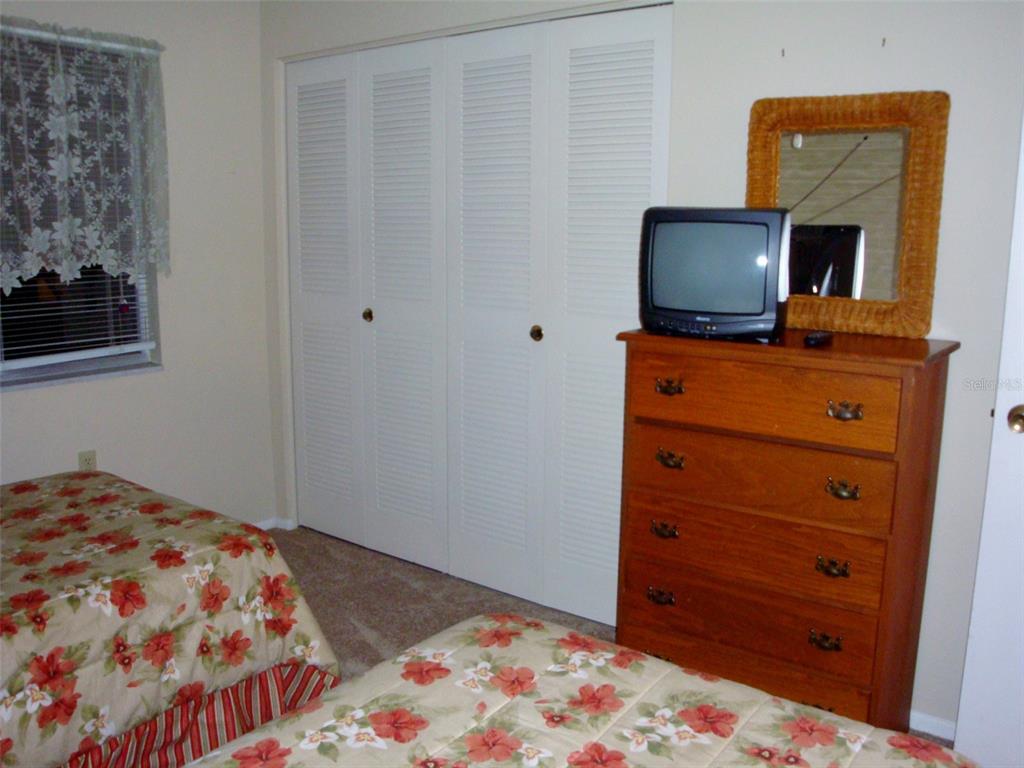 244 Cypress Lane, Unit 244 Oldsmar, FL 34677 - Photo 13 of 16 a bedroom with a bed and television