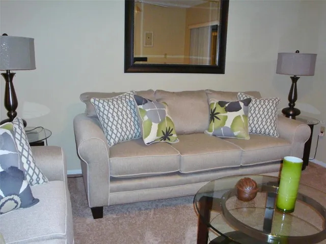 a living room with furniture and a lamp