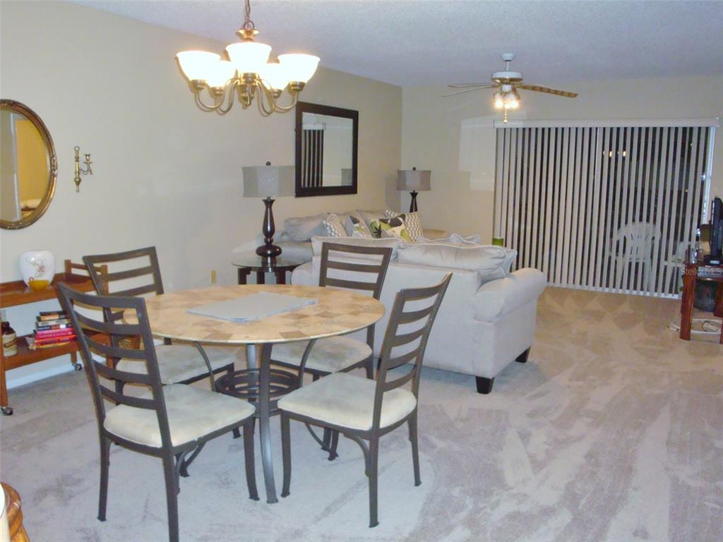 244 Cypress Lane, Unit 244 Oldsmar, FL 34677 - Photo 2 of 16 a view of a dining room with furniture and chandelier