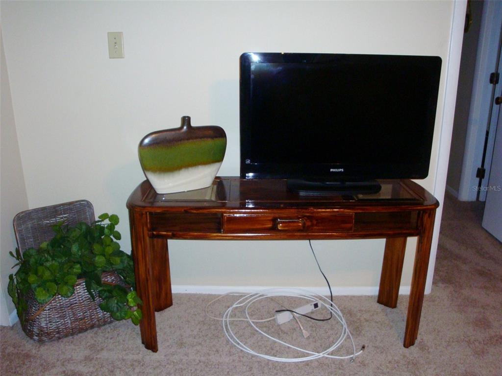 244 Cypress Lane, Unit 244 Oldsmar, FL 34677 - Photo 5 of 16 a living room with furniture and a flat screen tv