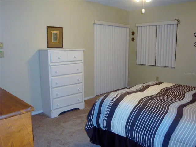 a bedroom with a bed and cabinet