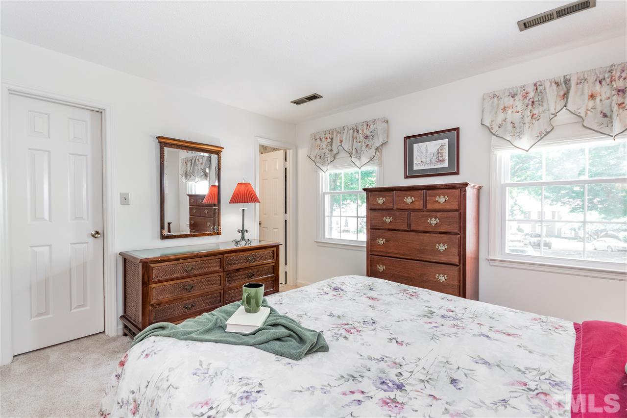 2880 Wycliff Road Raleigh, NC 27607 - Photo 12 of 23 a bedroom with a bed and a dresser