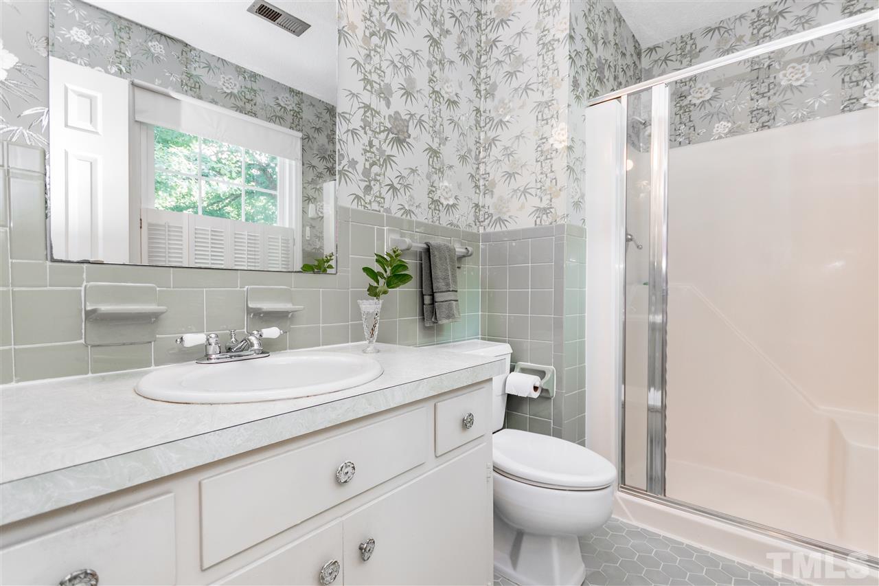 2880 Wycliff Road Raleigh, NC 27607 - Photo 13 of 23 a bathroom with a sink toilet and shower