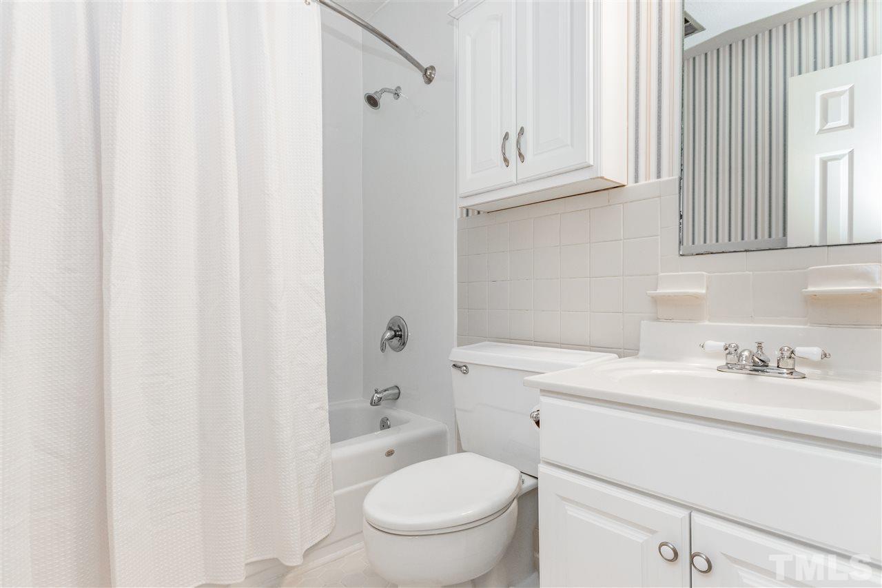 2880 Wycliff Road Raleigh, NC 27607 - Photo 14 of 23 a bathroom with a sink toilet vanity and tub