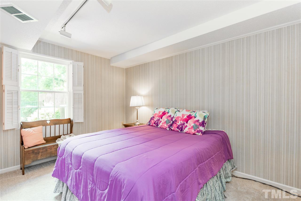 2880 Wycliff Road Raleigh, NC 27607 - Photo 16 of 23 a bedroom with a large bed and a large window with outer view