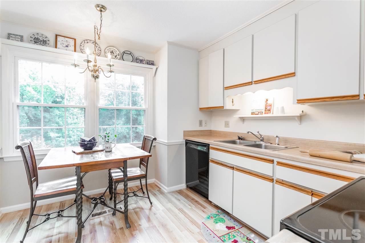2880 Wycliff Road Raleigh, NC 27607 - Photo 6 of 23 a kitchen with a table chairs and cabinets
