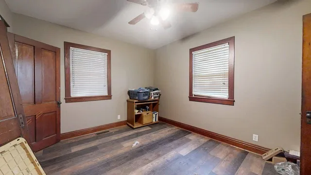 a view of room with window and wooden floor