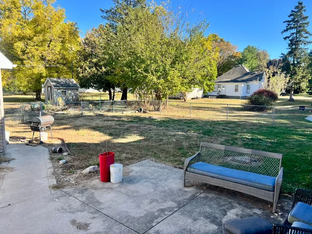 a view of a backyard with swimming pool