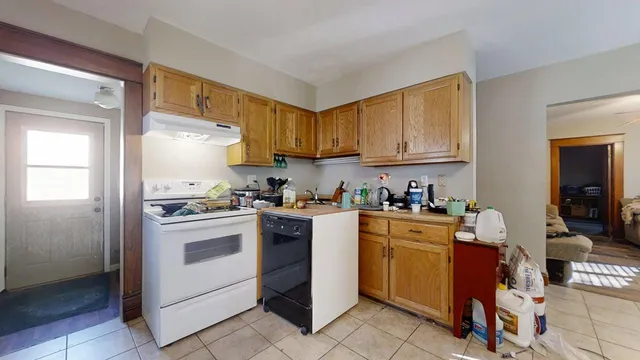 a kitchen with a stove top oven sink and cabinets