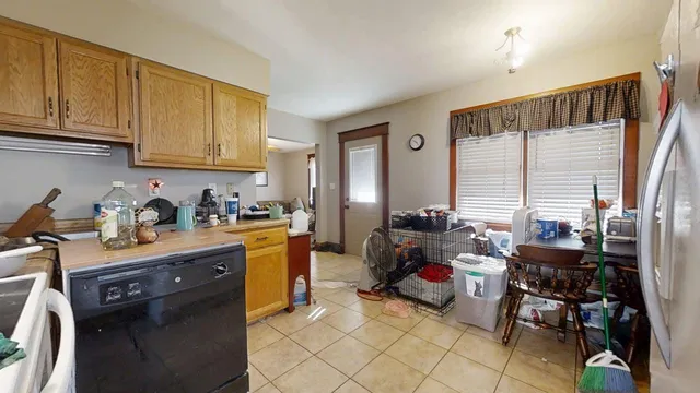 a kitchen with sink refrigerator and cabinets