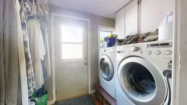 a view of a hallway with washer and dryer