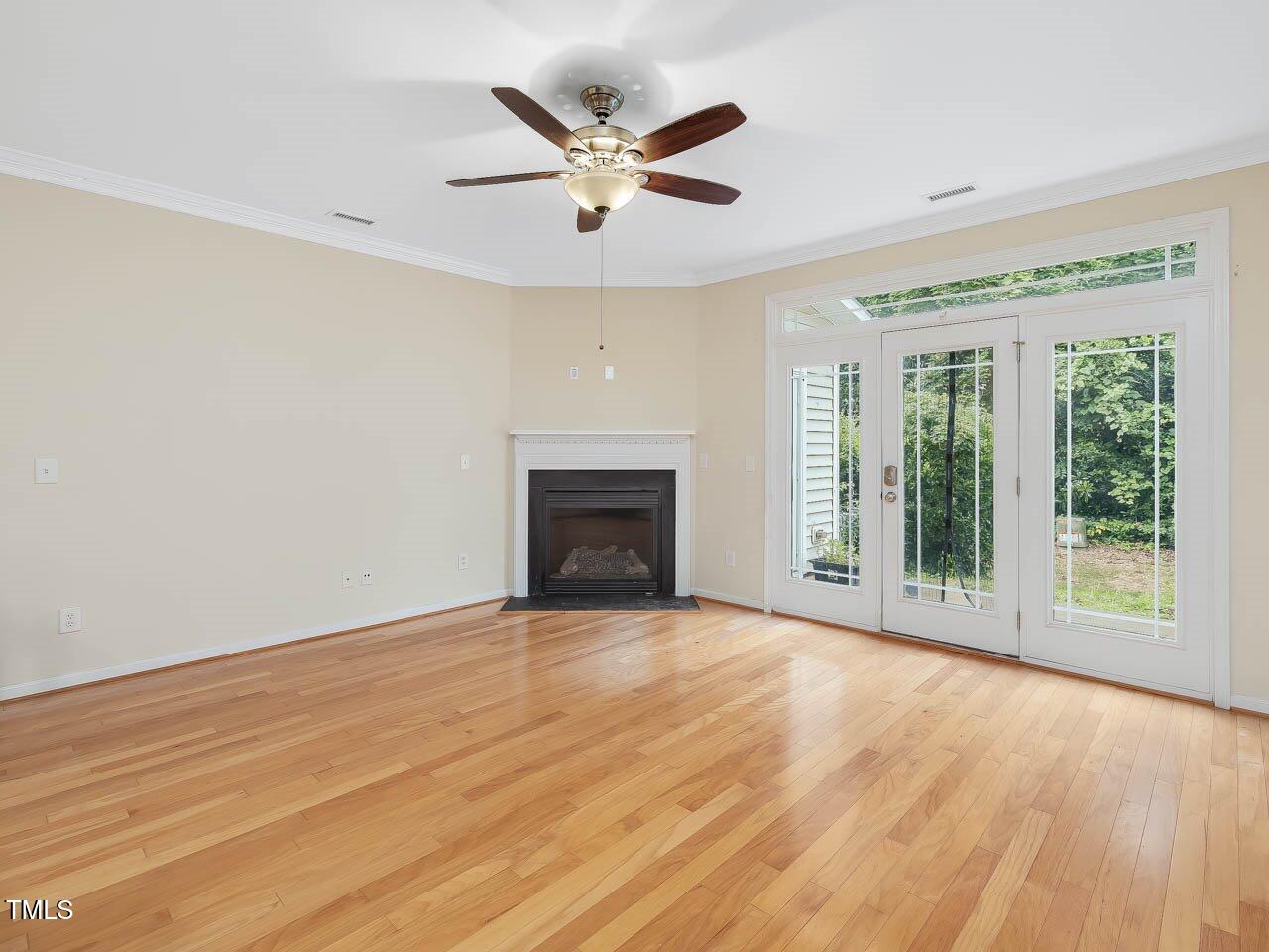 4719 Altha Street Raleigh, NC 27606 - Photo 5 of 19 a view of an empty room with wooden floor and a window