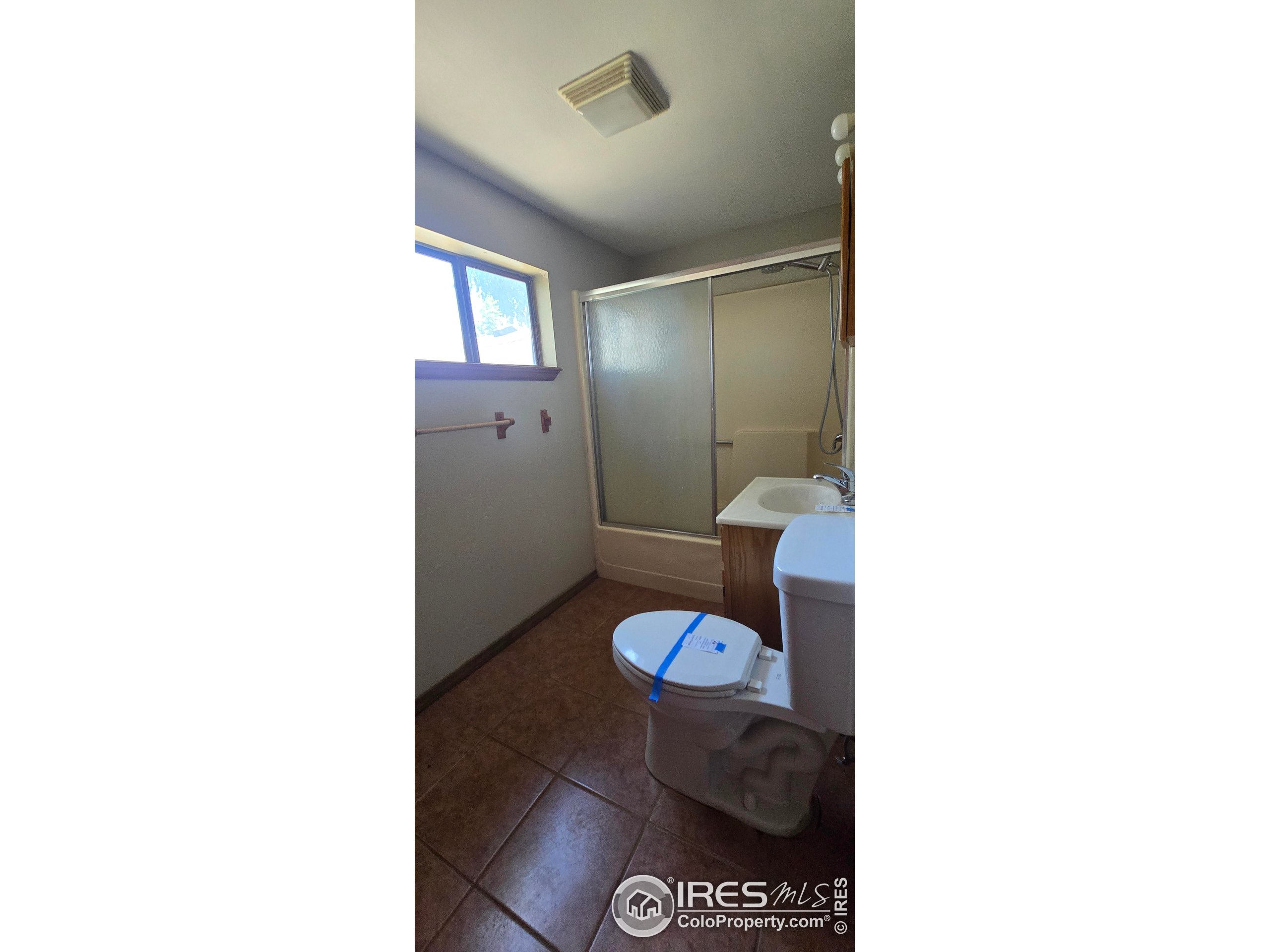 312 Main Street Wiggins, CO 80654 - Photo 5 of 8 a bathroom with a toilet and a sink