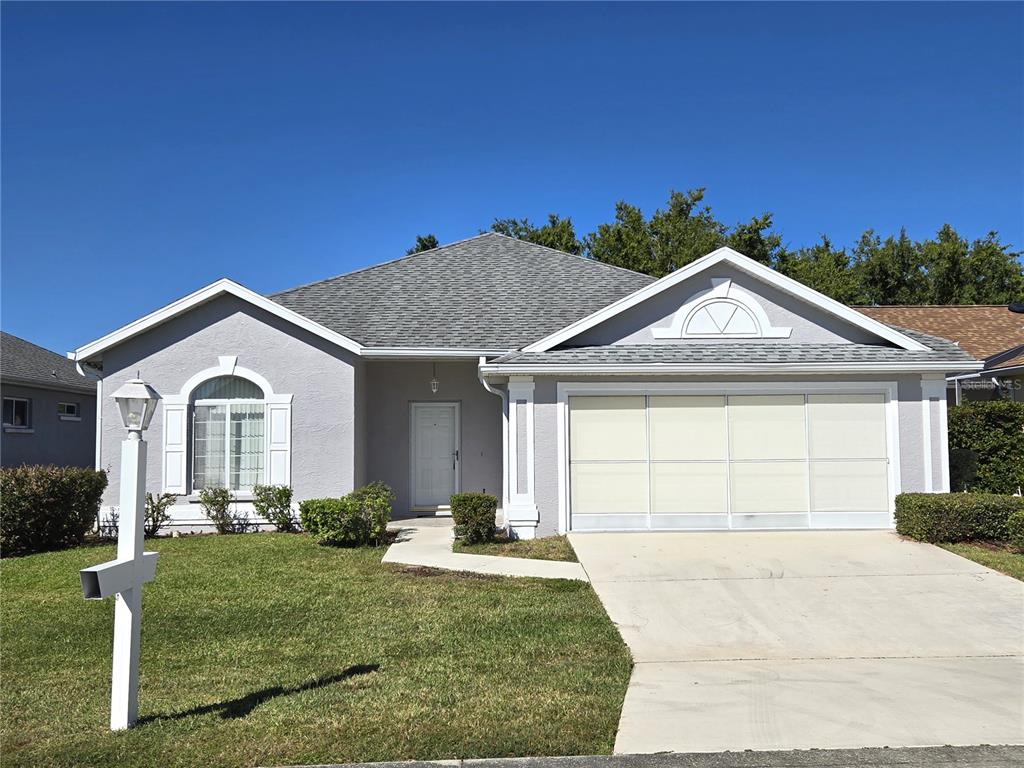 2352 Northwest 53rd Avenue Road Ocala, FL 34482 - Photo 1 of 1 a front view of a house with a yard and garage