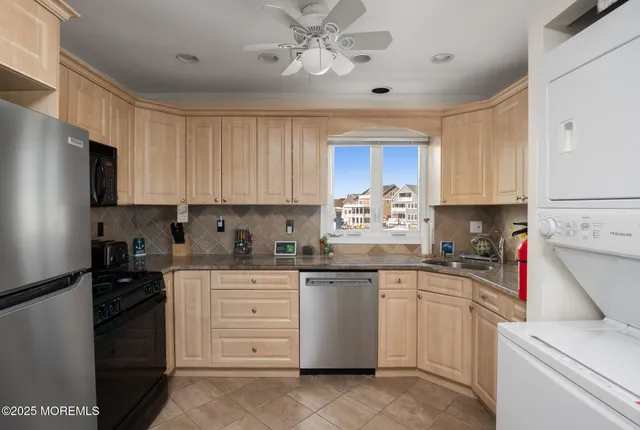 a kitchen with cabinets appliances a sink and a counter top space