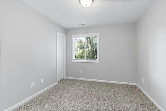 a bathroom with a granite countertop sink toilet mirror and bathtub