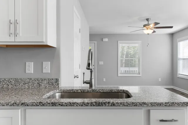 a bathroom with sink granite and bathtub