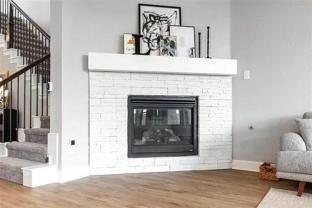 a view of living room with furniture and a fireplace