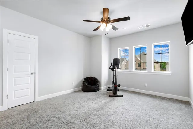 a view of workspace with a window and ceiling fan