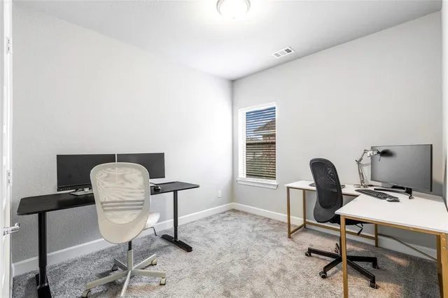 a work room with furniture and windows