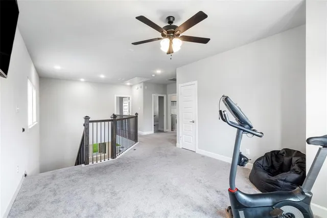 a view of a livingroom with furniture and a ceiling fan