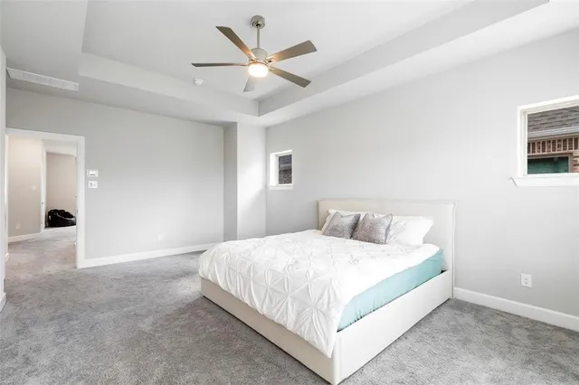 a bedroom with a large bed and a chandelier