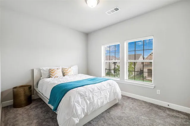 a bedroom with a bed and a large window