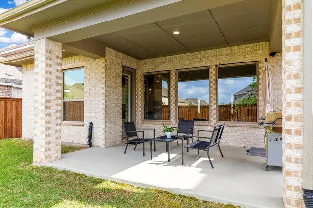 a building outdoor space with patio furniture and potted plant