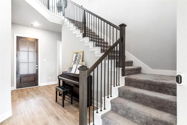 a view of entryway and hall with wooden floor
