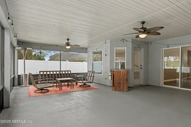 an aerial view of a city with lots of residential buildings and ocean view in back