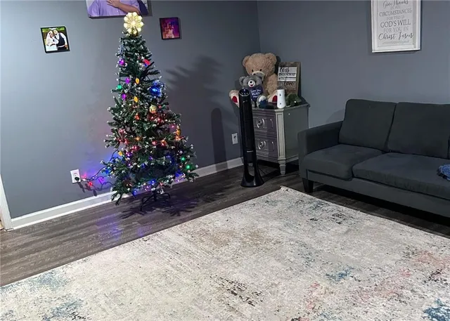 a living room with hard wood flooring and a couch