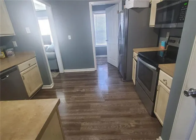 a bathroom with a granite countertop sink and a toilet
