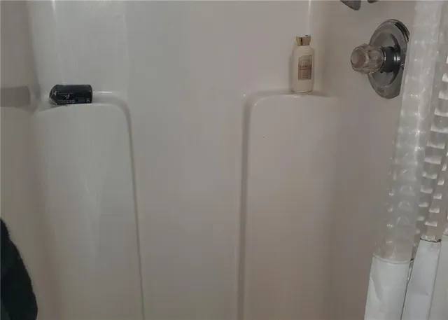 a bed sitting in a bedroom and wooden floor