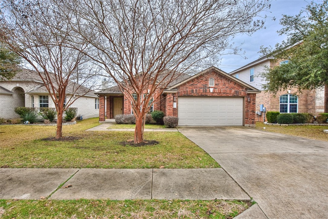 1402 Tumbling River Drive Leander, TX 78641 - Photo 1 of 1 a front view of a house with a yard and garage