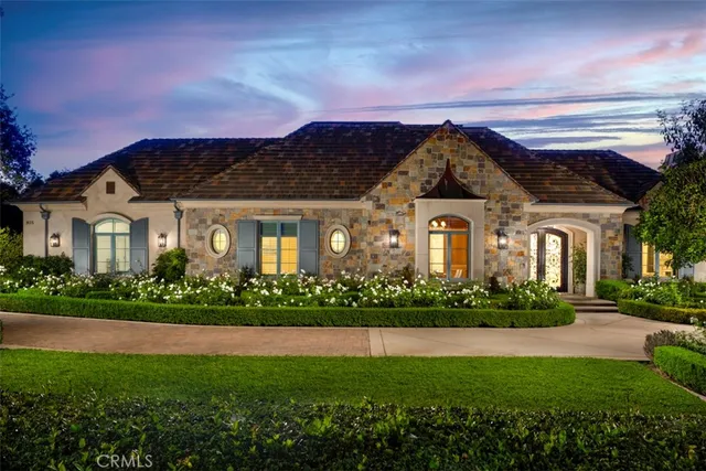 a front view of a house with a garden