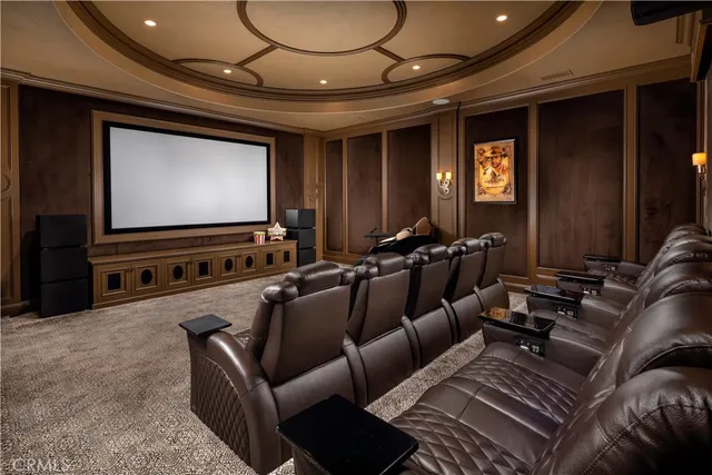 a living room with furniture a fireplace and a chandelier