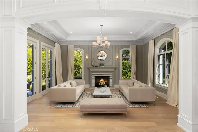 a living room with furniture and a chandelier