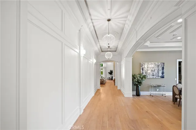 a living room with fireplace furniture and a chandelier