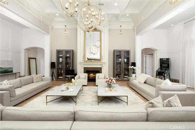 a living room with furniture and a chandelier