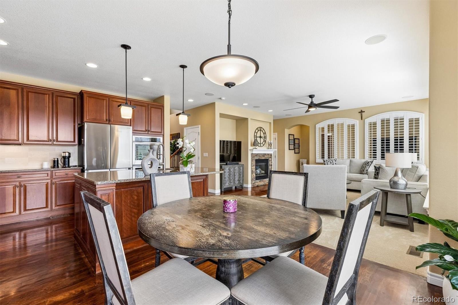 11025 Grayledge Circle Highlands Ranch, CO 80130 - Photo 11 of 46 a dining room with furniture a chandelier and wooden floor