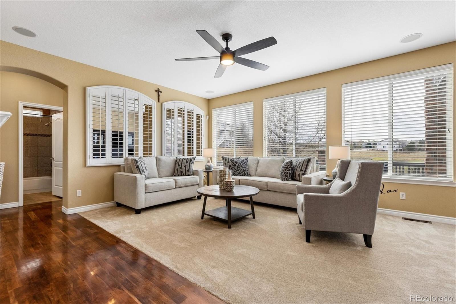 11025 Grayledge Circle Highlands Ranch, CO 80130 - Photo 13 of 46 a living room with furniture and a large window with wooden floor